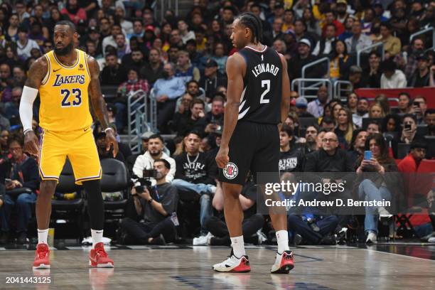 Kawhi Leonard of the LA Clippers and LeBron James of the Los Angeles Lakers look on during the game on February 28, 2024 at Crypto.Com Arena in Los...