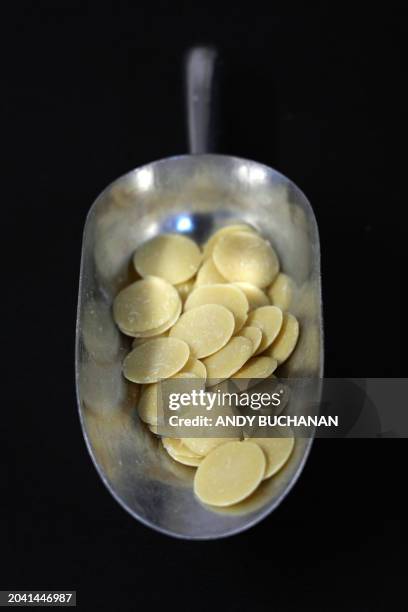 Photograph taken on February 14, 2024 shows white chocolate used by Chocolatier and owner of Fetcha Chocolates, Fiona McArthur to create vegan...