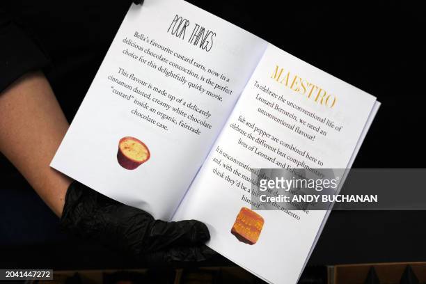 Photograph taken on February 14, 2024 shows the text presentations for the vegan chocolates created in honour of the movies "Poor Things" and...
