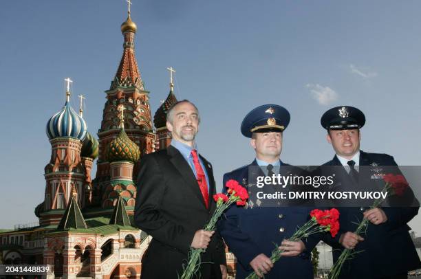 Russian cosmonaut Yuri Lonchakov , US astronaut Michael Fincke and his compatriot, space tourist Richard Garriott pose near Saint Basil cathidral at...