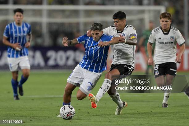 Godoy Cruz's midfielder Hernan Lopez and Colo-Colo's midfielder Esteban Pavez fight for the ball during the Copa Libertadores' second round second...