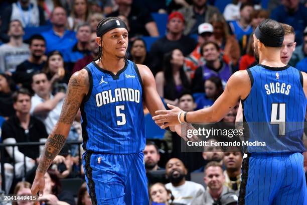 Paolo Banchero high fives Jalen Suggs of the Orlando Magic during the game against the Utah Jazz on February 29, 2024 at Amway Center in Orlando,...