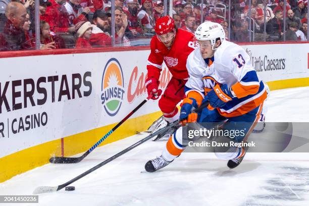 Mathew Barzal of the New York Islanders picks up the loose puck in front of Ben Chiarot of the Detroit Red Wings during the second period at Little...