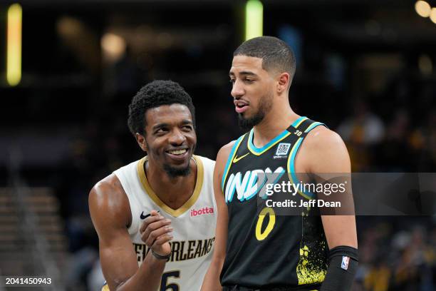 Herb Jones of the New Orleans Pelicans & Tyrese Haliburton of the Indiana Pacers looks on during the game on February 28, 2024 at Gainbridge...