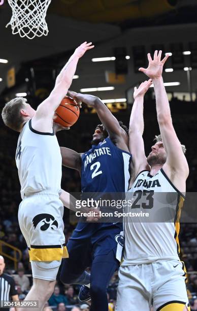 Iowa guard Josh Dix tries to block a shot by Penn State guard D'Marco Dunn during a college basketball game between the Penn State Nittany Lions and...
