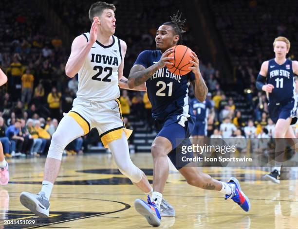 Penn State guard Rayquawndis Mitchell drives to the basket as Iowa forward Patrick McCaffery defends during a college basketball game between the...