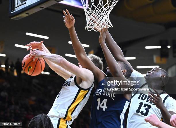 Iowa guard Josh Dix tries to secure a rebound after a shot by Penn State forward Demetrius Lilley during a college basketball game between the Penn...