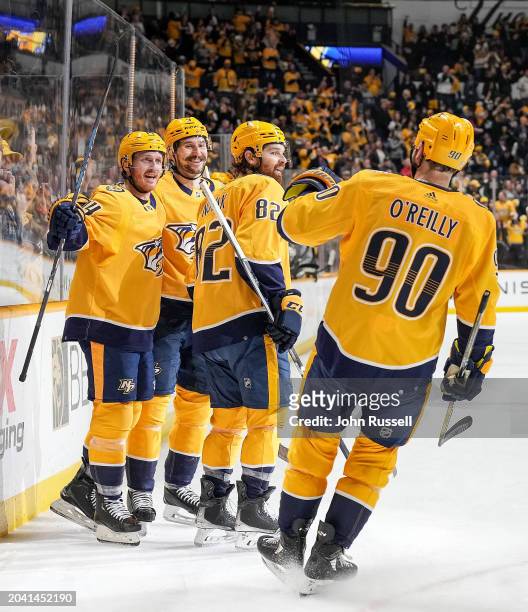 Filip Forsberg celebrates his goal with Gustav Nyquist, Tommy Novak and Ryan O'Reilly of the Nashville Predators celebrates his goal against the...