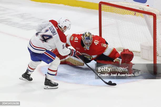 Goaltender Anthony Stolarz of the Florida Panthers stops a shot by Nick Suzuki of the Montreal Canadiens during the shoot out at the Amerant Bank...
