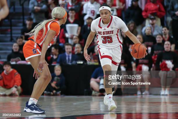 State Wolfpack guard Zoe Brooks brings the ball up court as Syracuse Orange guard Alaina Rice defends during the college basketball game between the...