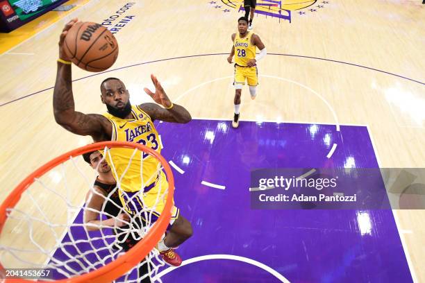 LeBron James of the Los Angeles Lakers drives to the basket during the game against the Washington Wizards on February 29, 2024 at Crypto.Com Arena...