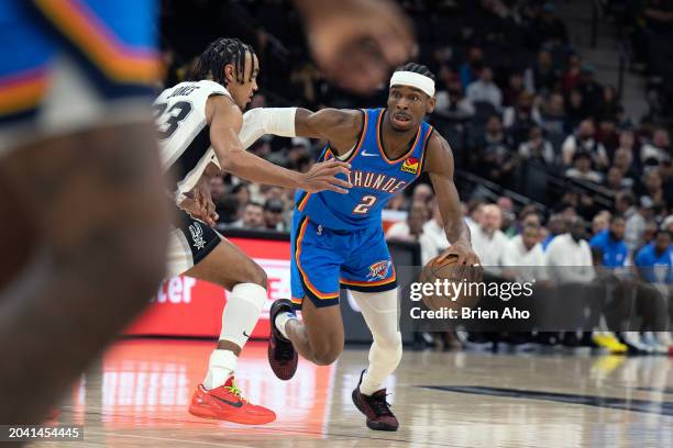 Guard Shai Gilgeous-Alexander of the Oklahoma City Thunder drive towards the basket during a game against the San Antonio Spurs at Frost Bank Center...