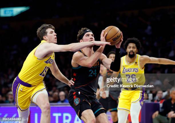 Corey Kispert of the Washington Wizards looks to shoot against Austin Reaves of the Los Angeles Lakers during the first half at Crypto.com Arena on...