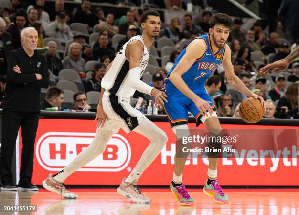 Center Chet Holmgren of the Oklahoma City Thunder drives towards the basket against Victor Wembanyama of the San Antonio Spurs at Frost Bank Center...