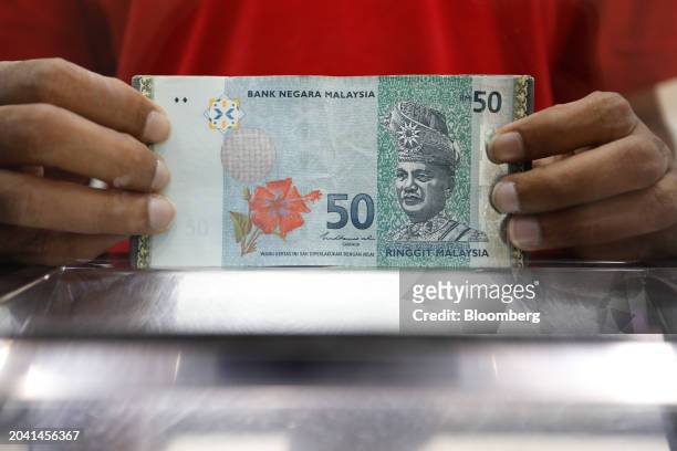 Malaysia fifty ringgit banknotes at a currency exchange store in Kuala Lumpur, Malaysia, on Friday, March. 1, 2024. Policymakers have stepped up...