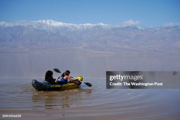 Dennis Parrish, left, and Penny Sinisi from Henderson, Nevada kayak on Lake Manly in Death Valley National Park, California on Feb. 27, 2024.