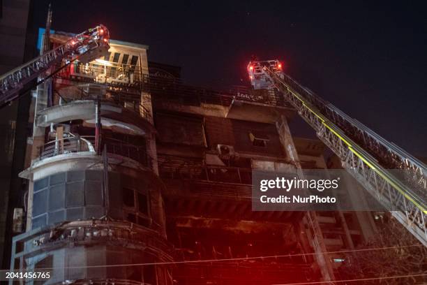 Firefighters are rescuing people from the roof after a fire broke out in a multi-storey building in Dhaka, Bangladesh, on February 29, 2024. At least...