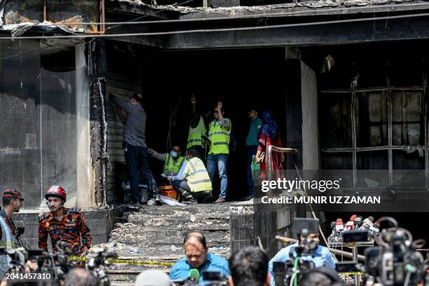 Firefighters and forensic expert inspect a commercial building, a day after a fire accident in Dhaka on March 1, 2024. Bangladesh firefighters said...