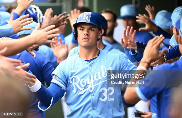 Nick Pratto of the Kansas City Royals celebrates with teammates in the dugout after hitting a three run home run against the Chicago Cubs during the...