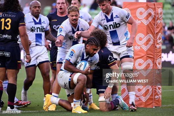 Blues player Hoskins Sotutu is congratulated by teammates after scoring a try during the Super Rugby match between the Auckland Blues and the Otago...