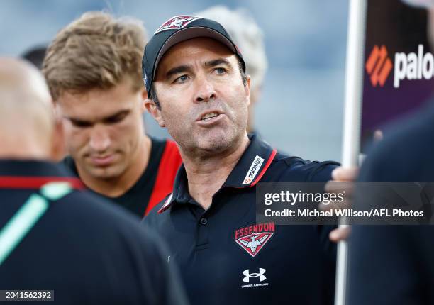 Brad Scott, Senior Coach of the Bombers addresses his players during the 2024 AFL AAMI Community Series match between the Geelong Cats and Essendon...