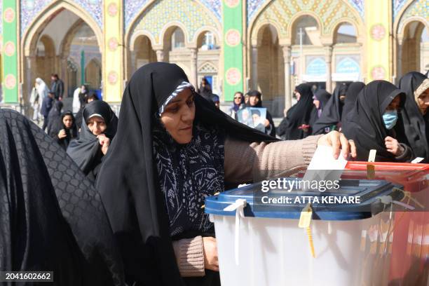 An Iranian woman casts her ballot during elections to select members of parliament and a key clerical body, in Tehran on March 1, 2024.