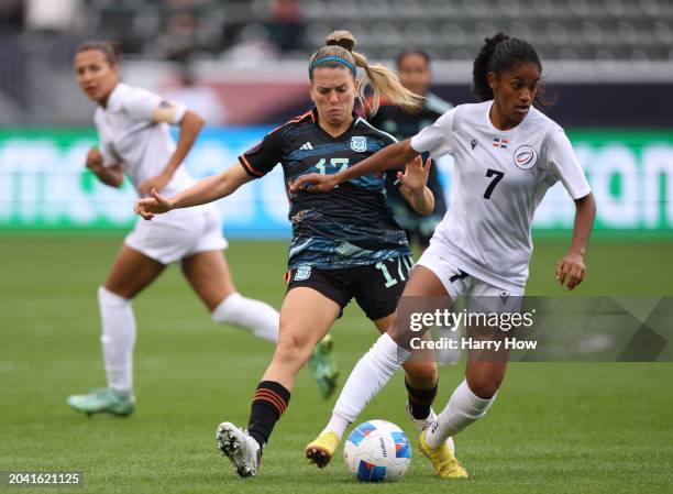 Winibian Peralta of Dominican Republic turns with the ball away from Camila Gomez Ares of Argentina during the first half at Dignity Health Sports...