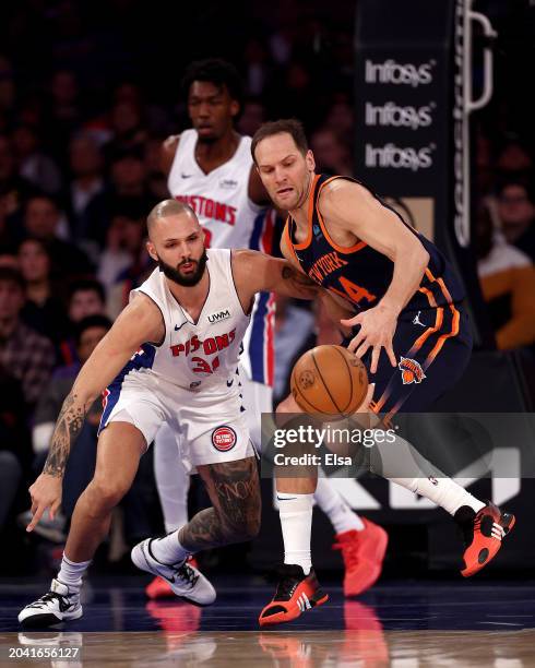 Evan Fournier of the Detroit Pistons and Bojan Bogdanovic of the New York Knicks go after the loose ball during the first half at Madison Square...