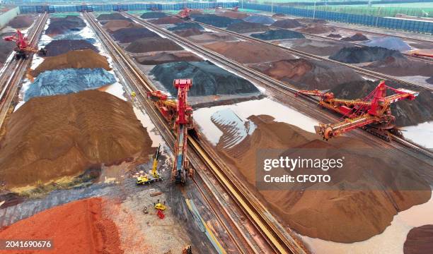 Bucket turbine performs an iron ore discharge operation at the iron ore storage yard of Taicang Wugang Terminal Co., Ltd. In Suzhou, Jiangsu...