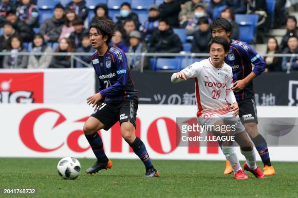 Shinya Yajima of Gamba Osaka controls the ball against Keiji Tamada of Nagoya Grampus during the J.League J1 match between Gamba Osaka and Nagoya...
