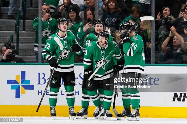 Logan Stankoven of the Dallas Stars celebrates with Wyatt Johnston, Derrick Pouliot and Joel Hanley after scoring his first career NHL goal during...