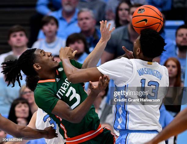 Christian Watson of the Miami Hurricanes battles Jalen Washington of the North Carolina Tar Heels for a rebound during the second half at the Dean E....