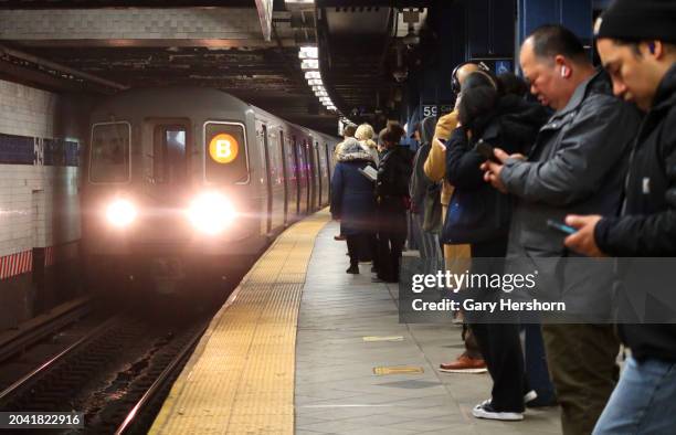 People wait to board a B line subway train at the Columbus Circle - 59th Street station on February 26 in New York City.