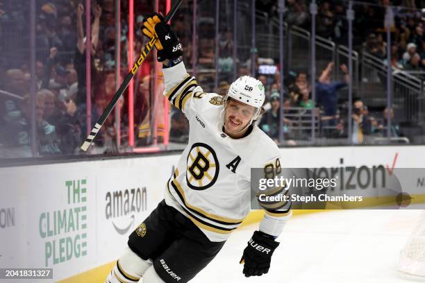 David Pastrnak of the Boston Bruins celebrates his goal and 700th NHL point during the first period against the Seattle Kraken at Climate Pledge...