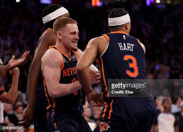 Josh Hart of the New York Knicks is congratulated by teammate Donte DiVincenzo after Hart scored the game winner against the Detroit Pistons at...