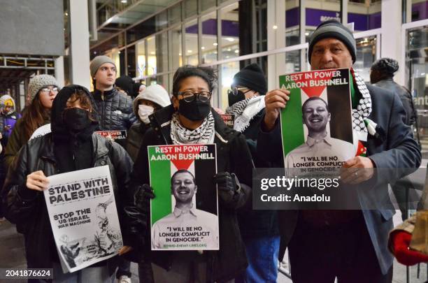 Protesters hold signs in front of the Israeli consulate during candlelight vigils to honor Aaron Bushnell's self-sacrifice for peace in Chicago,...