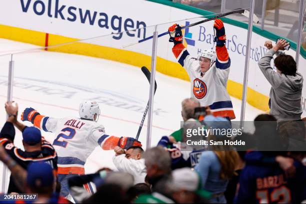 Bo Horvat of the New York Islanders celebrates with Mike Reilly after scoring the game winning goal in overtime to defeat the Dallas Stars at...