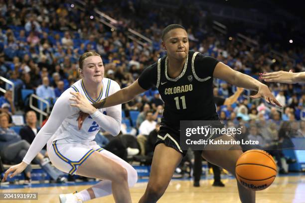 Quay Miller of the Colorado Buffaloes and Lina Sontag of the UCLA Bruins reach for a loose ball during the second half of a game at UCLA Pauley...