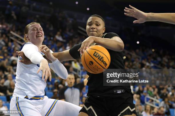 Quay Miller of the Colorado Buffaloes and Lina Sontag of the UCLA Bruins reach for a loose ball during the second half of a game at UCLA Pauley...