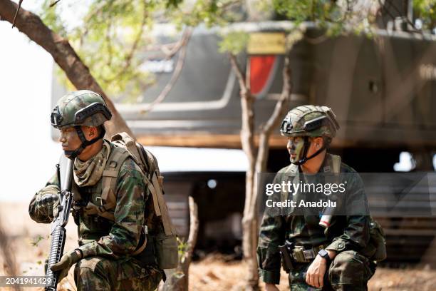 Soldiers with guns keep their position in the forest while over 1500 military personnel representing Thailand, the United States of America, and...