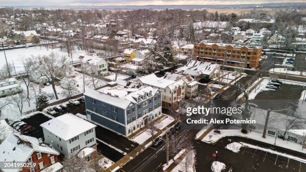 snow-covered greenwood ave is lined with houses in residential madison, nj - greenwood stock pictures, royalty-free photos & images