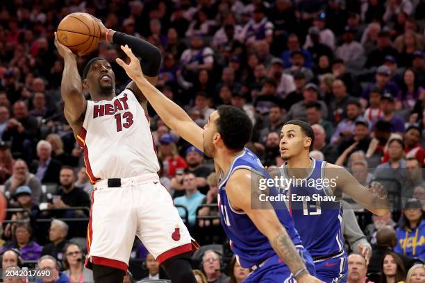 Bam Adebayo of the Miami Heat shoots over Trey Lyles and Keegan Murray of the Sacramento Kings in the second half at Golden 1 Center on February 26,...