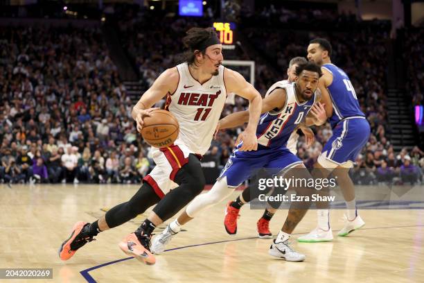 Jaime Jaquez Jr. #11 of the Miami Heat is guarded by Malik Monk of the Sacramento Kings in the second half at Golden 1 Center on February 26, 2024 in...