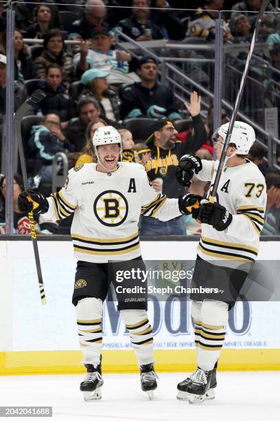 David Pastrnak of the Boston Bruins celebrates his hat trick during the third period against the Seattle Kraken at Climate Pledge Arena on February...