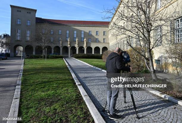 This photo taken on February 26, 2024 shows a cameraman filming the building of the regional court in Krems, Lower Austria prior to the start of a...