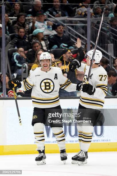 David Pastrnak of the Boston Bruins celebrates his hat trick during the third period against the Seattle Kraken at Climate Pledge Arena on February...