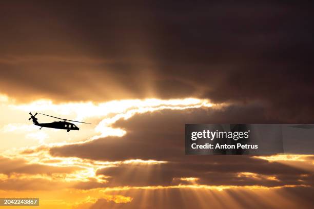 utility military helicopter on the background of the sunset sk - attack helicopter stock pictures, royalty-free photos & images