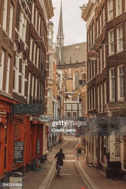 moody view of empty amsterdam street at early morning - amsterdam sunrise stock pictures, royalty-free photos & images