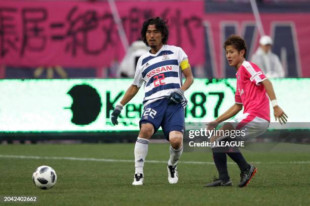 Yuji Nakazawa of Yokohama F.Marinos controls the ball against Yoichiro Kakitani of Cerezo Osaka during the J.League J1 match between Cerezo Osaka and...