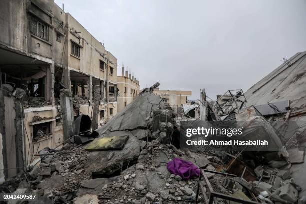 People inspect damage and recover items from their homes following Israeli air strikes on February 27, 2024 in Rafah, Gaza. As of Tuesday 878 had...